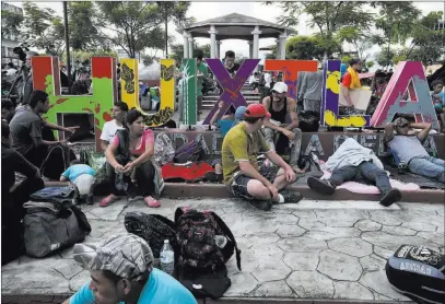  ?? Moises Castillo ?? The Associated Press Central American migrants making their way to the U.S. rest in a park after arriving Monday in Huixtla, Mexico.