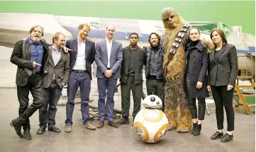  ??  ?? US actor Mark Hamill, US director Rian Johnson, Prince Harry, Prince William, Boyega, Chewbacca and Ridley pose during a tour of the Star Wars sets at Pinewood studios in Iver Heath, west of London, Britain on Apr 19, 2016. — Reuters file photo