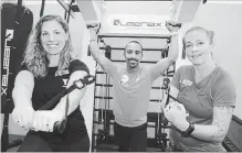  ?? PAUL FORSYTH NIAGARA THIS WEEK ?? Sam Cameron, Chico Anderi and Melody Cosby with the YMCA Niagara Falls branch try out some of the new equipment on the Precor Queenax training machine in the new functional fitness studio in the branch.