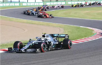  ?? Photo: AP ?? Mercedes driver Valtteri Bottas of Finland leads Ferrari driver Sebastian Vettel of Germany at the start of yesterday’s Japan GP