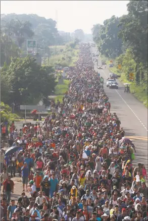  ?? Moises Castillo / Associated Press ?? Central American migrants walking to the U.S. start their day departing Ciudad Hidalgo, Mexico, on Sunday.