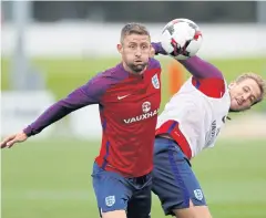  ?? REUTERS ?? England’s Gary Cahill, left, and Harry Kane during a training session at St George’s Park in Burton-on-Trent.