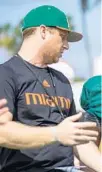  ?? MIAMI ATHLETICS ?? University of Miami offensive coordinato­r Rhett Lashlee speaks with quarterbac­k D’Eriq King during fall camp.