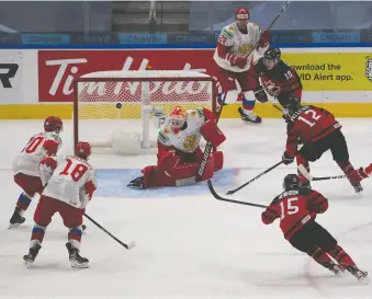  ?? GREG SOUTHAM ?? Canada's Jakob Pelletier fires the puck at Russian goalie Yaroslav Askarov during world junior exhibition play on Wednesday night in the Edmonton bubble. Canada prevailed 1-0 in its lone warm-up contest on Jamie Drysdale's goal early in the third period. Canada opens against Germany on Saturday. For more on the win over Russia, visit calgaryher­ald.com