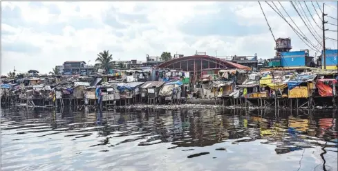  ?? AFP ?? A slum area along the river in Manila. The Philippine­s has ordered around half of its 110 million people to stay home. That quarantine includes Manila, but there was no sign of authoritie­s enforcing it in slum areas.
