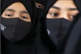  ?? AIJAZ RAHI — THE ASSOCIATED PRESS ?? Indian Muslim students wearing hijabs and face masks gather to meet student activists in Kundapur in the Udupi district, Karnataka state, India.