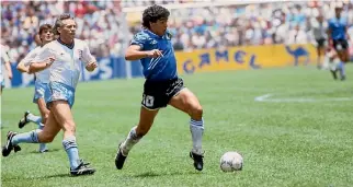  ?? GETTY IMAGES ?? Diego Maradona weaves his way through the England defence at the 1986 World Cup.