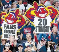  ?? AP/RON SCHWANE ?? Cleveland Indians fans celebrate after their team’s 2-0 victory over the Detroit Tigers on Tuesday night. The Indians have won 20 games in a row, which is tied for the third-longest winning streak ever in the major leagues.