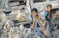  ?? AP PHOTO ?? Iraqi children flee through the rubble as Iraqi forces continue their advance against Islamic State militants in the Old City of Mosul, Iraq, Tuesday.