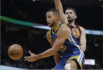  ?? TONY DEJAK — THE ASSOCIATED PRESS ?? The Warriors’ Stephen Curry (30) passes against Cavaliers’ Kevin Love (0) in the second half on Thursday in Cleveland.