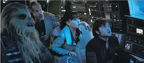  ?? DISNEY ?? Joonas Suotamo, left, as Chewbacca, Woody Harrelson as Tobias Beckett, Emilia Clarke as Qi’ra and Alden Ehrenreich as Han Solo in the second stand alone Star Wars movie Solo: A Star Wars Story.