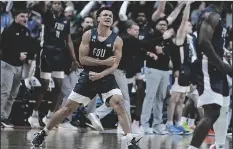  ?? MICHAEL CONROY/AP ?? FAIRLEIGH DICKINSON GUARD GRANT SINGLETON (4) celebrates after a basket against Purdue in the second half of a game in Columbus, Ohio, on Friday.