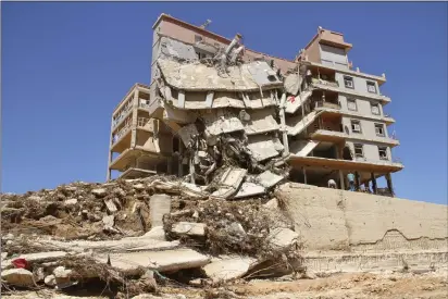  ?? YOUSEF MURAD — THE ASSOCIATED PRESS ?? Damage from massive flooding is seen in Derna, Libya, Wednesday. Search teams are combing streets, wrecked buildings, and even the sea to look for bodies in Derna, where the collapse of two dams unleashed a massive flash flood that killed thousands of people.