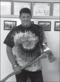  ?? Submitted Photo ?? JOB WELL DONE: Tim McDorman holds an engraved ax that was presented to him for 28 years of service with Piney Fire Department. McDorman began his service at the department in May 1990 and became the fire chief in 1998.