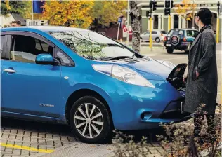  ?? PHOTO: ALEX LOVELLSMIT­H ?? Early adopters . . . An EV owner charges up at the University of Otago charger.