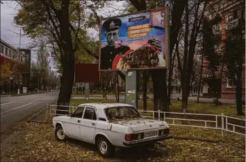  ?? Bernat Armangue / Associated Press ?? A partially torn-off Russian billboard in Kherson, southern Ukraine. The text reads in Russian: “People of Kherson is proud of Russia.”