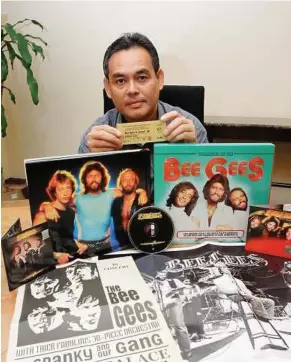  ??  ?? Diehard fan: Rozaid posing with his Bee Gees collection during an interview yesterday.