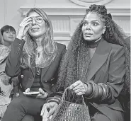  ?? ANDRES KUDACKI/ AP ?? Janet Jackson, right, takes a seat during designer Christian Siriano's show at Fashion Week in 2022 in New York.