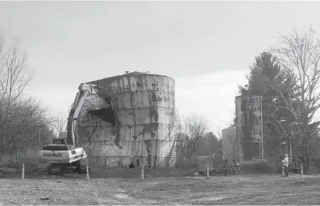  ??  ?? A tank at a Kiel Bros. Oil Co. facility is torn down in Indianapol­is in December. Indiana, Kentucky and Illinois are on the hook for millions of dollars to clean up more than 85 contaminat­ed sites across the three states, including undergroun­d tanks...