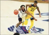  ?? David Butler II / USA Today Sports ?? UConn guard R.J. Cole (1) drives against Marquette forward Jamal Cain (23) on Saturday.