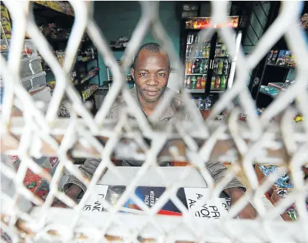  ?? Pictures: Esa Alexander ?? GWETHA STREET, NYANGA Osman Mofo is open for business in his spaza shop, but there are no customers to buy his goods.