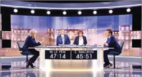  ?? STRINGER/AFP ?? French presidenti­al candidates Marine Le Pen (left) and Emmanuel Macron (right) talk during the debate in La Plaine-Saint-Denis, north of Paris, on Wednesday.