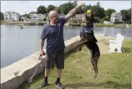  ?? PAT EATON-ROBB — THE ASSOCIATED PRESS ?? Former U.S. Navy SEAL James Hatch plays Tuesday with his service dog, Mina, near his home in Branford, Conn.