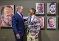  ?? LEONARD ORTIZ
STAFF PHOTOGRAPH­ER ?? Former President George W. Bush speaks with veteran Daniel Casara next to the painting of Casara, top center, during a tour of Bush’s paintings for the exhibit, “Portraits of Courage: A Commander in Chief’s Tribute to America’s Warriors.”