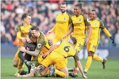  ??  ?? Brighton’s players celebrate after Brighton win the penalty shoot-out after the English FA Cup quarter-final football match between Millwall and Brighton and Hove Albion at The Den in south London. - AFP photo