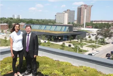  ?? VINCE TALOTTA/TORONTO STAR ?? Heela Omarkhail, manager of community partnershi­ps with Daniels, and Dominic Tompa, highrise sales manager, stand on the green roof at Daniels Spectrum with the Aquatic Centre, park and refurbishe­d Regent Park neighbourh­ood behind them.