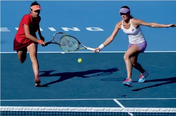  ?? — AFP ?? Sania Mirza ( left) and Martina Hingis of Switzerlan­d in action against Julia Goerges of Germany and Czech Republic’s Karolina Pliskove in the China Open women’s doubles quarter- final in Beijing on Thursday. Sania- Hingis won 7- 6, 6- 4.