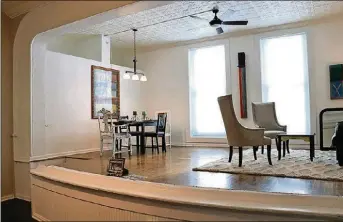  ??  ?? Tall windows add abundant daylight, while stylish lighting includes a triple hanging fixture over the dining area and a central ceiling paddle fan with a light kit.