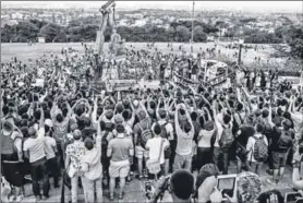  ??  ?? The dethroning of Cecil John Rhodes, after the throwing of human faeces on the statue and the agreement of the university to the demands of the students for it’s removal. The University of Cape Town, April 9 2015