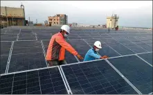  ?? XINHUA ?? Technician­s examine solar panels installed at a factory in Gazipur on the outskirts of Dhaka, Bangladesh, on Jan 3. The South Asian country is upgrading its energy networks.