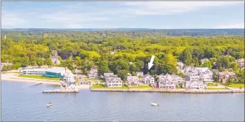  ??  ?? This Madison home, just three doors from the Madison Beach Club, has an incredible number of windows that provide an abundance of light and views of Tuxis Island.