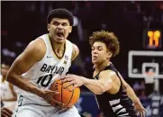  ?? Charlie Riedel/associated Press ?? Rayj Dennis, left, missed his first seven shots but finished with 13 points in Baylor’s win Thursday.