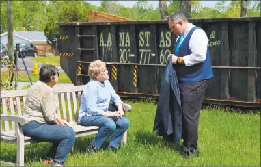  ?? Clare Dignan / Hearst Connecticu­t Media ?? Adele Volpe, center, talks with Hamden Mayor Curt B. Leng about the damage to her house on October Hill Road done by last year's tornado. A dumpster full of debris and home wreckage sits behind them.