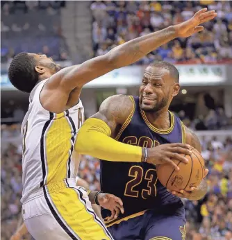  ?? MATT KRYGER, THE INDIANAPOL­IS STAR ?? LeBron James, driving against the Pacers’ Paul George, had a huge series to lead the Cavaliers, who closed the season with a 9-13 slump, to a first-round sweep.