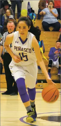  ?? Sheila Miller/The Taos News ?? Adrianna Tafoya of the Peñasco Lady Panthers makes her way across the court during the Saturday 59-53 win over Cimarron (Jan. 19).