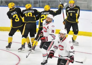  ?? DAVE SCHWARZ ?? Players from No. 16 American Internatio­nal College players celebrate a goal Friday during their 2-1 NCAA upset win over Ryan Poehling’s team, heavily favoured No. 1 seed St. Cloud State in Fargo, N.D.