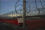  ?? MARISA SCHWARTZ TAYLOR — THE NEW YORK TIMES ?? Fencing and wire surround an entrance to the legal complex at Guantánamo Bay in Cuba. The war court there has four active cases.