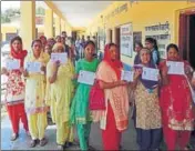  ?? PUNKAJ BHAARTIYA/HT ?? Voters showing their identity cards as they queue up to exercise their right to franchise during the Bhoranj assembly bypoll in Hamirpur district on Sunday.