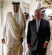  ?? CONTRIBUTE­D BY ALEXANDERW. RIEDEL / U.S. STATE DEPARTMENT ?? Emir Tamimbin Hamad Al Thani (left) walkswith Secretary of State Rex Tillerson on Tuesday in Doha, Qatar. Qatar agreed to bolster its fifight against terrorism.