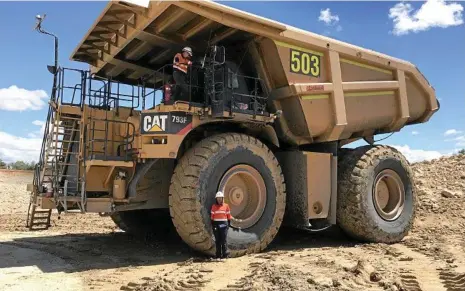  ?? PHOTOS: CONTRIBUTE­D ?? EXPERIENCE: New Hope Group vacation student Ashtika Devi stands by the wheel of New Acland’s largest mining truck, a CAT 793F.