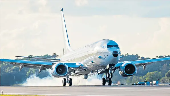  ??  ?? The first of nine RAF P-8A Poseidon aircraft lands at Naval Air Station Jacksonvil­le in Florida, where Royal Air Force personnel are being trained to operate it