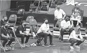  ?? BARBARA J. PERENIC/COLUMBUS DISPATCH ?? From left, managers Mike Mastroiann­i, Bryce Hawkins, Tyler Hicks and John Mccausland sit ready to assist during an Ohio State men’s basketball game against Michigan State at Value City Arena in Columbus on Jan. 31.