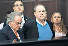  ??  ?? Held to account: movie mogul Harvey Weinstein (centre) faces trial next year