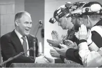  ?? Associated Press ?? n Environmen­tal Protection Agency Administra­tor Scott Pruitt, left, shakes hands with coal miners Thursday during a visit to Consol Pennsylvan­ia Coal Co.’s Harvey Mine in Sycamore, Pa. The Trump administra­tion wants to trash Obama-era rules to limit...