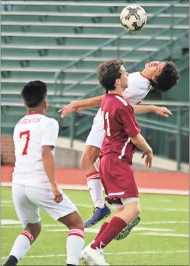  ??  ?? Jeremy Stewart / Rome News-Tribune
Rome’s Erick Luna (right) bends back to try and head the ball in front of Grady’s Caleb Weinstock and teammate Angel Morrente (7) during a Class 5A state playoff game Saturday at Barron Stadium.