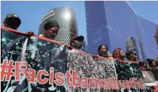  ?? TIMOTHY BERNARD ?? SCORES of #RacistBank­sMustFall protesters participat­e in a march to the banking precinct in Sandton City to make their voices heard. | African News Agency (ANA)